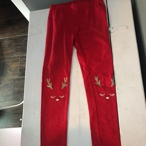 Soft red leggings with a reindeer on the knee
